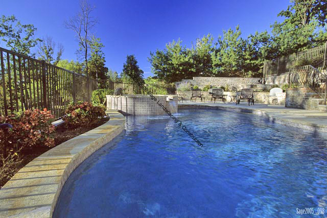 Concrete pool raised with patio and raised spa